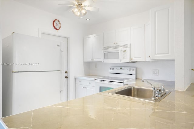 kitchen featuring white appliances, ceiling fan, sink, and white cabinets