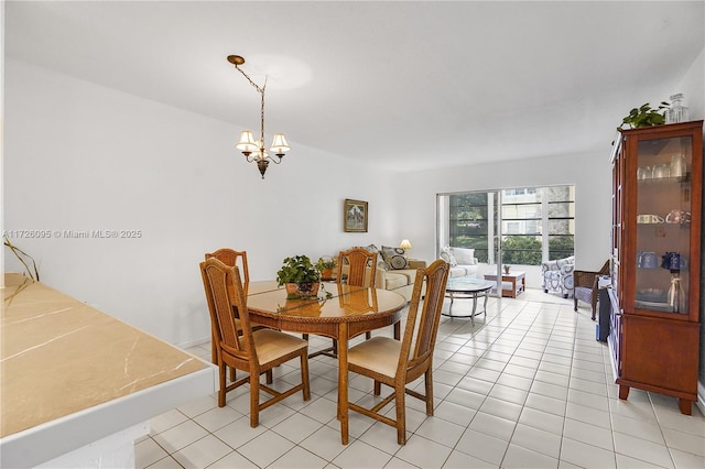 dining area with an inviting chandelier and light tile patterned floors