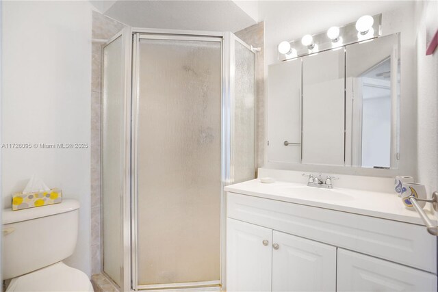 bathroom with toilet, walk in shower, and vanity