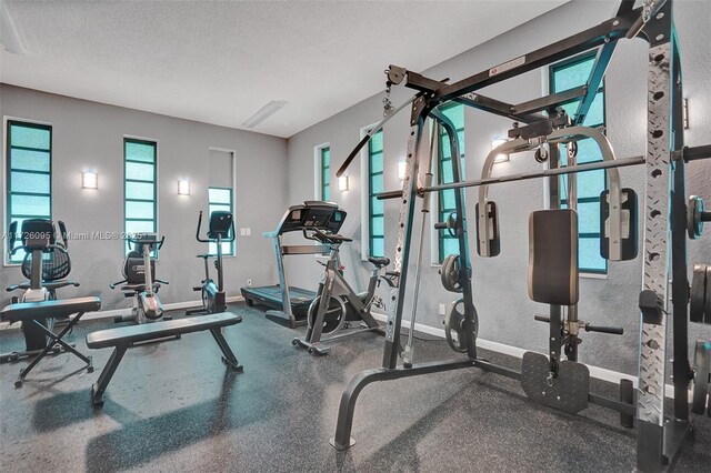 exercise room with a textured ceiling