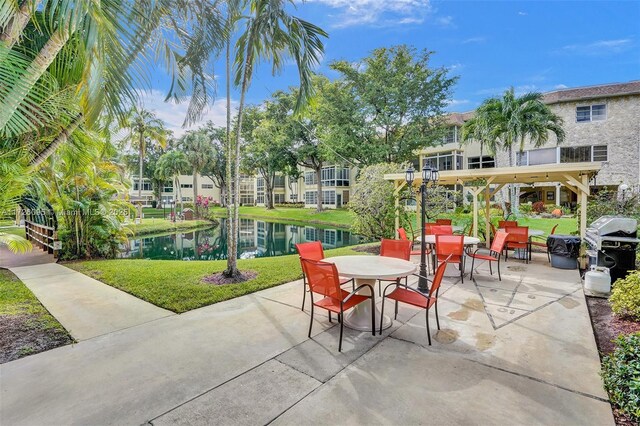 view of patio featuring area for grilling and a water view