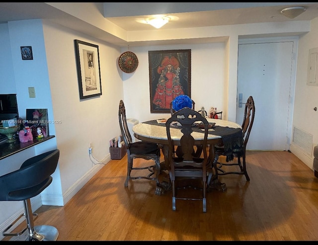 dining area with hardwood / wood-style floors