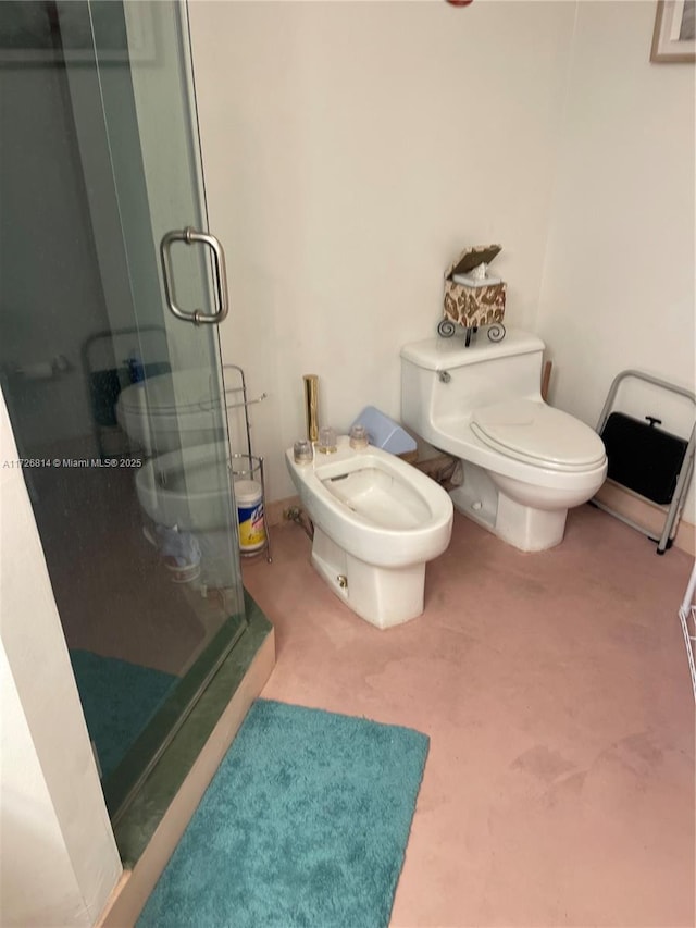 bathroom featuring a shower with door, a bidet, and toilet