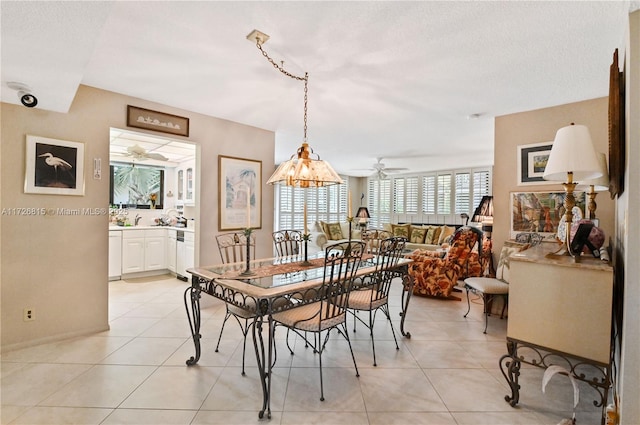 tiled dining area featuring ceiling fan