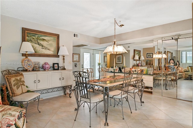 tiled dining space featuring a healthy amount of sunlight