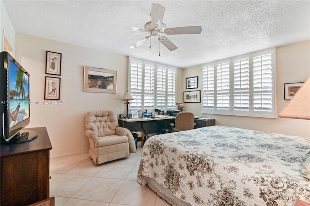 tiled bedroom with ceiling fan and a textured ceiling