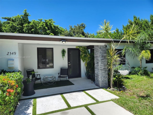 property entrance featuring a patio