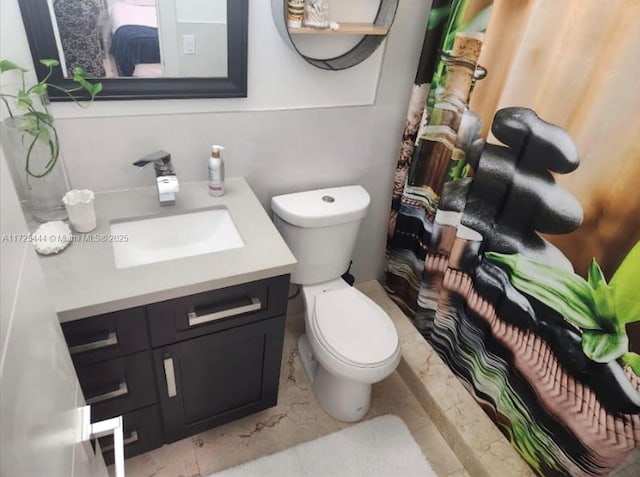 bathroom featuring toilet and vanity