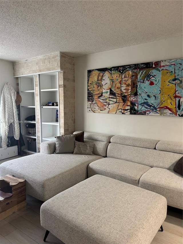 living room featuring hardwood / wood-style floors and a textured ceiling