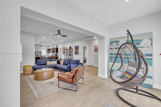 living room with light wood-type flooring and ceiling fan