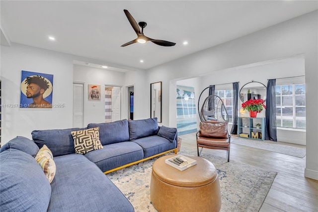 living room featuring ceiling fan and light wood-type flooring