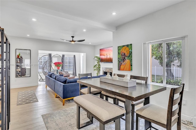 dining space with light hardwood / wood-style floors, ceiling fan, and a wealth of natural light