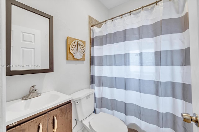 bathroom with toilet, vanity, and curtained shower