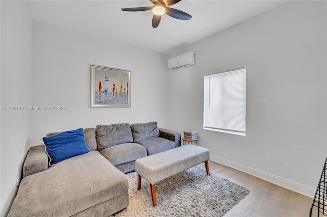 living room featuring ceiling fan, a wall mounted AC, and light wood-type flooring