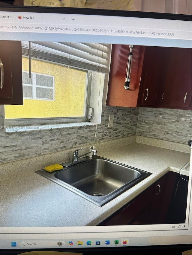 kitchen featuring sink and decorative backsplash