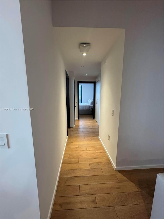 corridor with light hardwood / wood-style floors