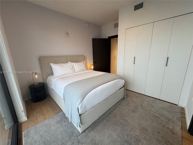 bedroom featuring light wood-type flooring and a closet