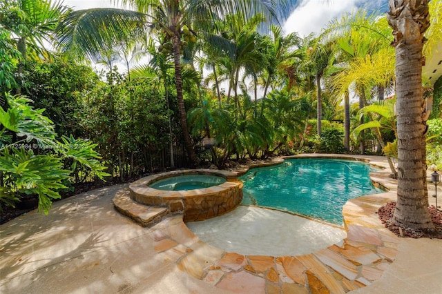 view of swimming pool featuring a patio area and an in ground hot tub