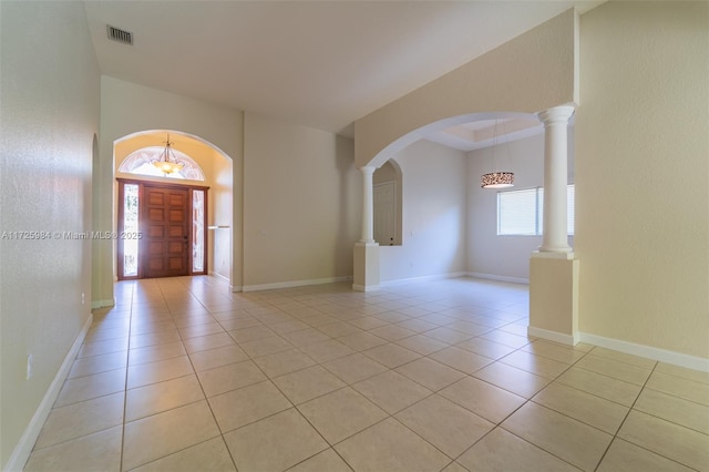 foyer featuring a notable chandelier, light tile patterned flooring, and plenty of natural light