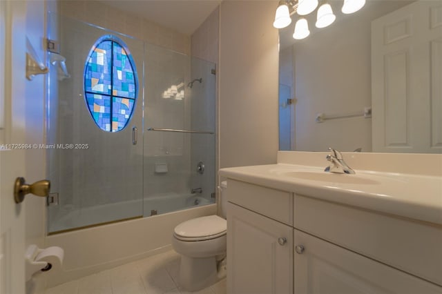 full bathroom with shower / bath combination with glass door, tile patterned flooring, toilet, and vanity