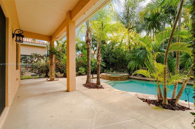 view of swimming pool with a patio area and an in ground hot tub