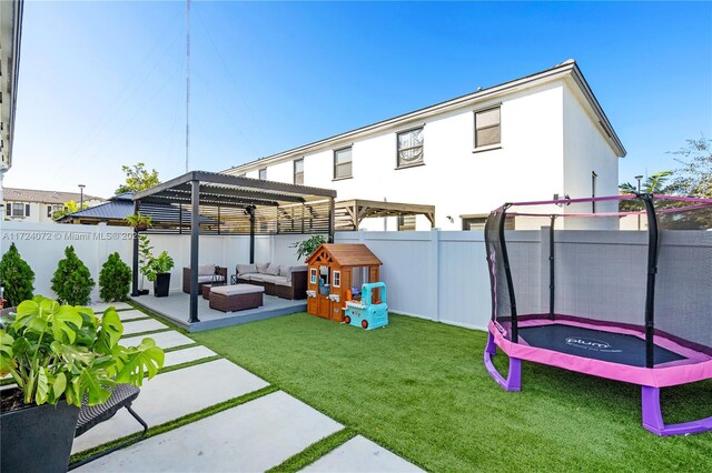 view of yard with a pergola, a patio, an outdoor hangout area, and a trampoline