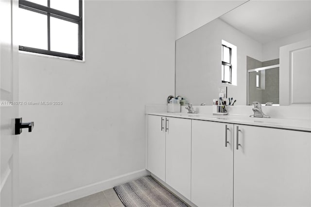 bathroom with vanity, tile patterned flooring, and a shower with door