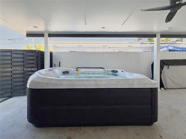 view of patio featuring ceiling fan and a hot tub