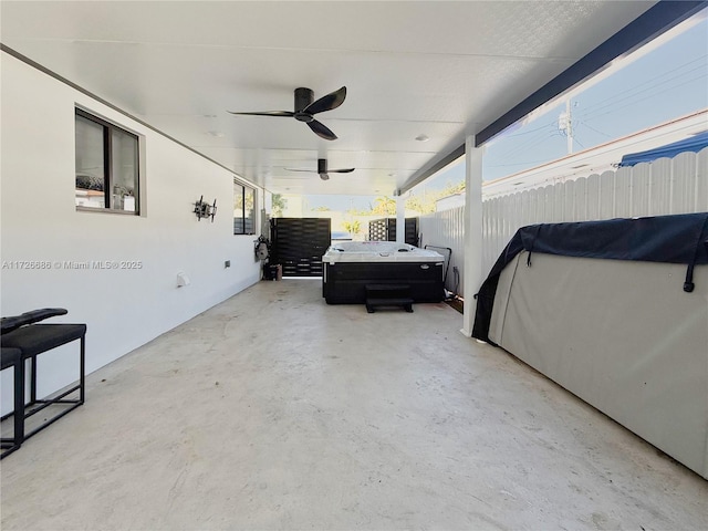 view of patio / terrace featuring ceiling fan and a hot tub