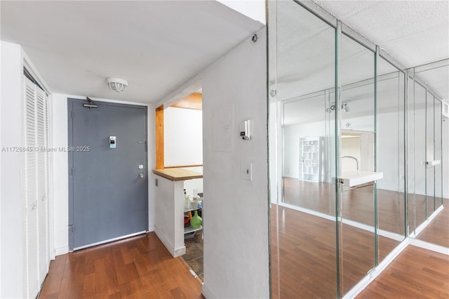 hall featuring baseboards and wood finished floors