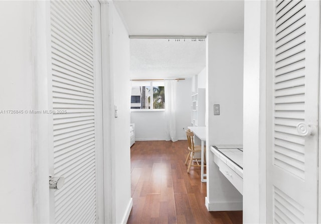 corridor with baseboards and dark wood-type flooring