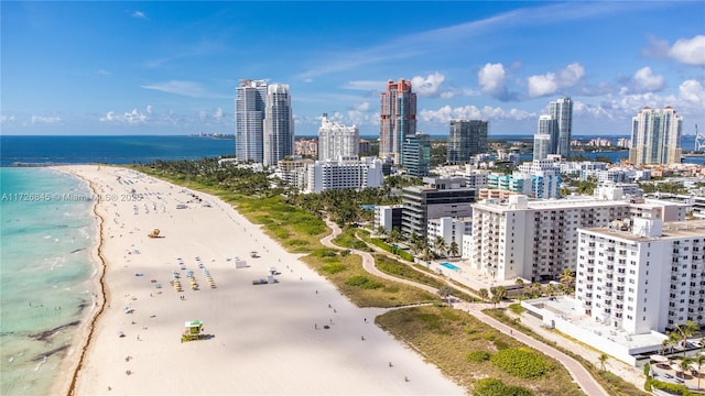 aerial view with a water view and a beach view