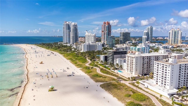 exterior space featuring a view of the beach, a city view, and a water view
