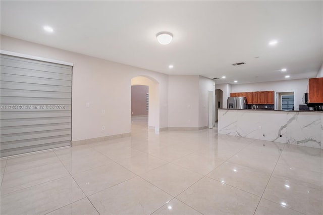 unfurnished living room with light tile patterned flooring