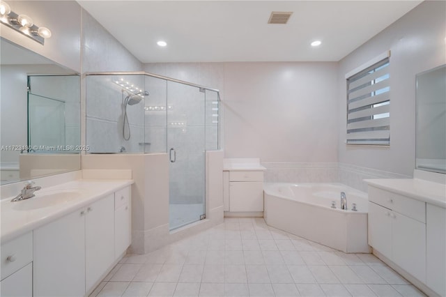 bathroom featuring tile patterned floors, vanity, and shower with separate bathtub