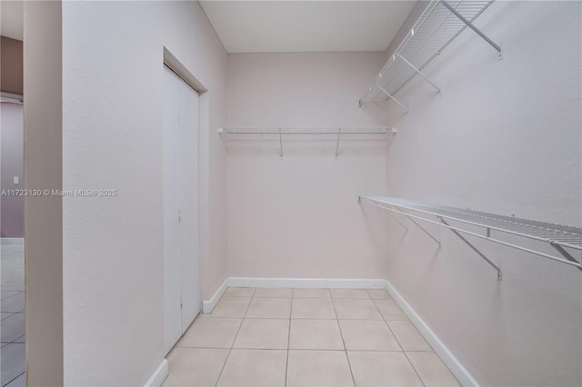 spacious closet featuring light tile patterned floors