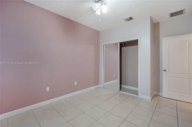 unfurnished bedroom with a closet and light tile patterned flooring