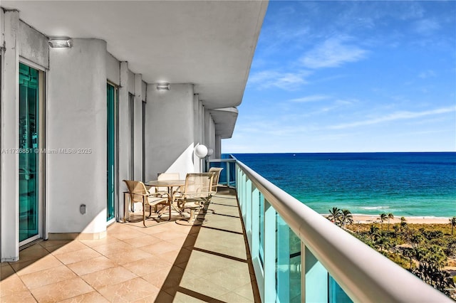 balcony with a view of the beach and a water view