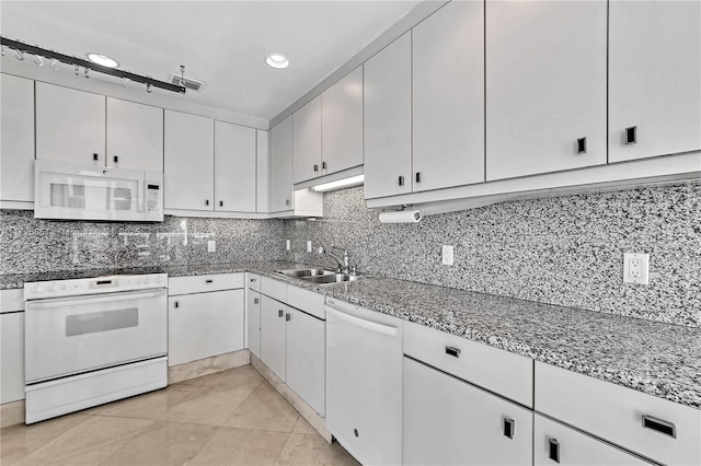 kitchen featuring white cabinetry, sink, white appliances, and backsplash