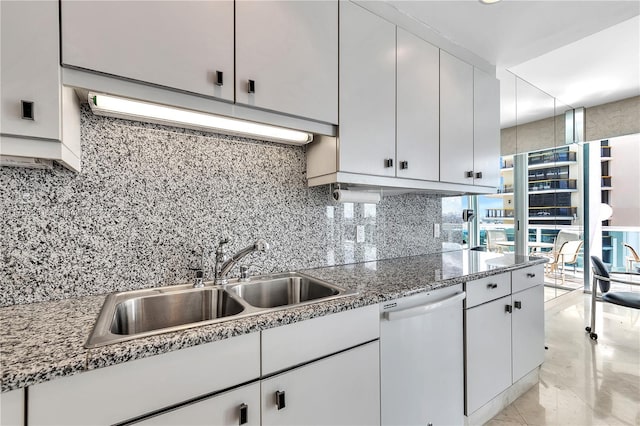 kitchen with white cabinetry, dishwasher, sink, and decorative backsplash