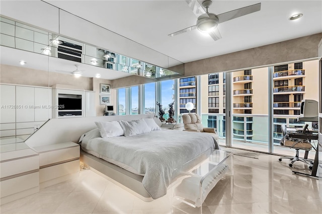 bedroom with ceiling fan and a wall of windows