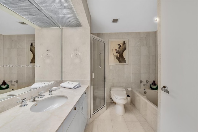 full bathroom featuring tile patterned floors, toilet, tile walls, vanity, and plus walk in shower