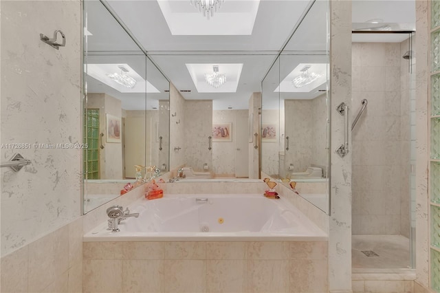 bathroom featuring a skylight and independent shower and bath