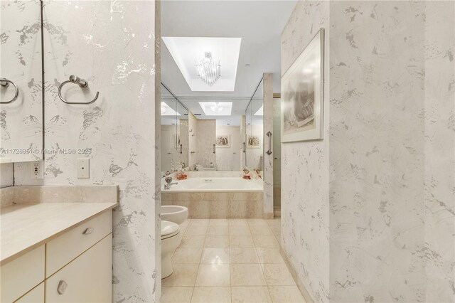 bathroom with a bidet, vanity, a relaxing tiled tub, tile patterned floors, and toilet