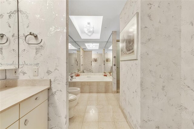 10101 Collins Ave Unit 11Dcaba, Bal Harbour, FL 33154 - bathroom with a bidet, vanity, a relaxing tiled tub, tile patterned floors, and toilet