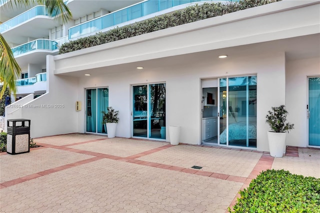 doorway to property with a patio area