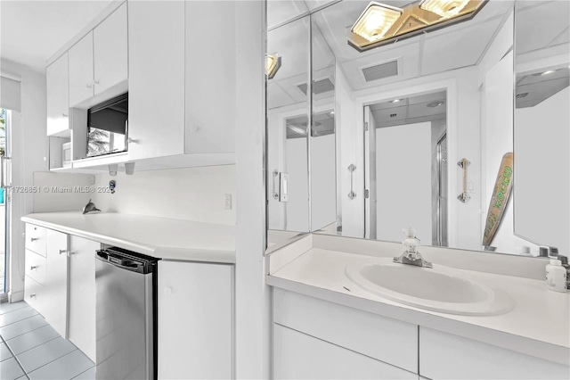 bathroom with tile patterned flooring and vanity