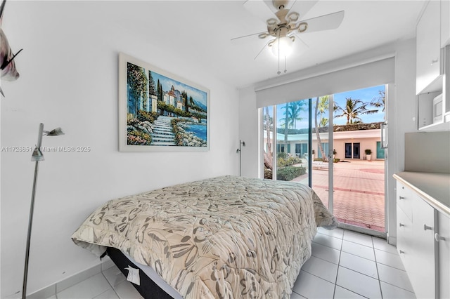 bedroom featuring ceiling fan, light tile patterned floors, and access to outside