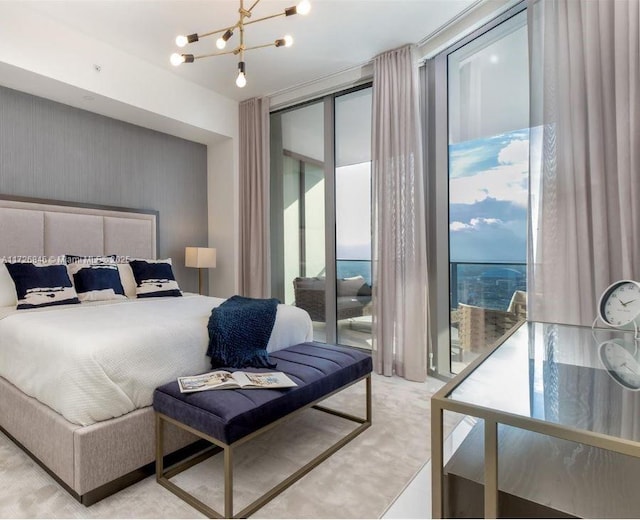 bedroom with a chandelier and a wall of windows