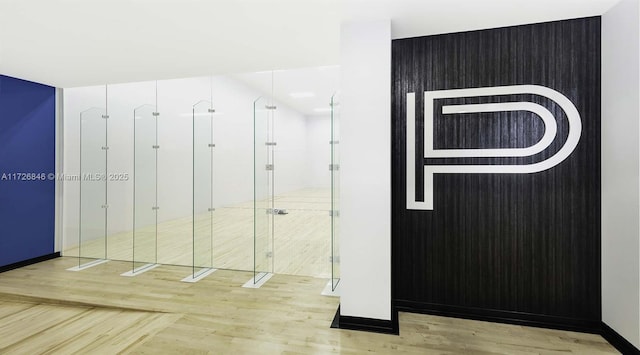 bathroom featuring hardwood / wood-style floors and a shower with door